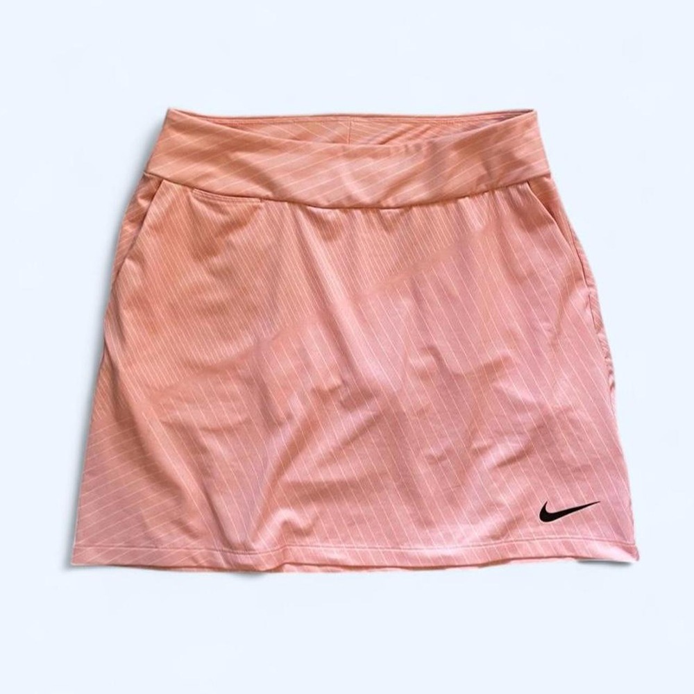 Pink Nike tennis skort with subtle vertical stripes, size XS